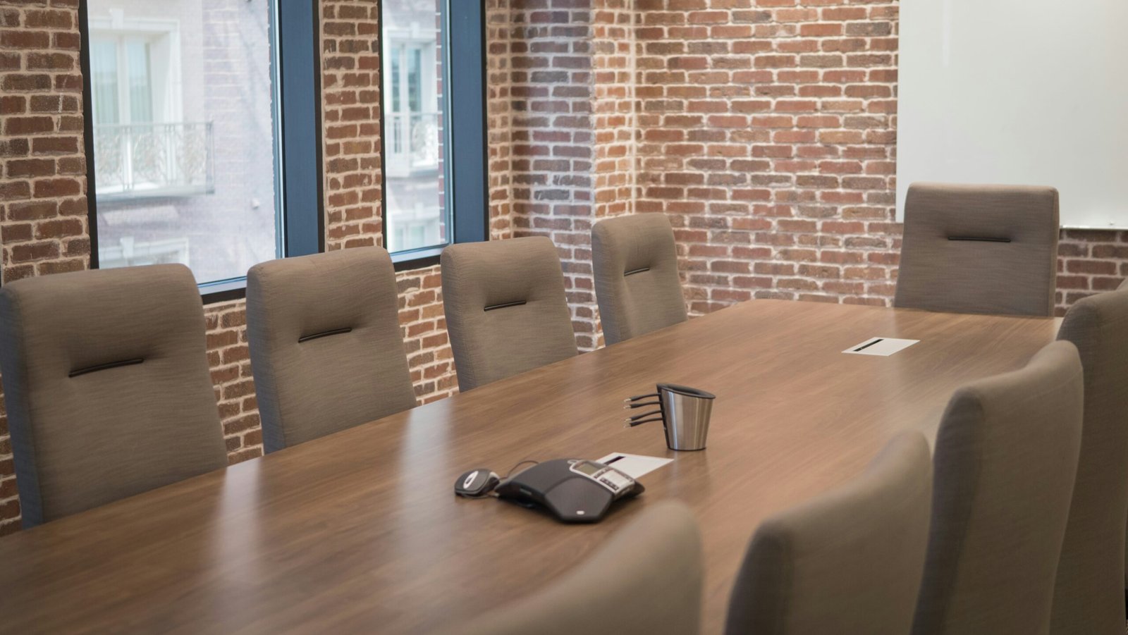 a conference room with a wooden table and chairs